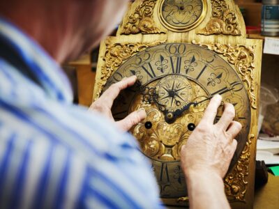 A clock maker working on antique clock