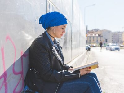Arabian young woman wearing hijab outdoor reading book