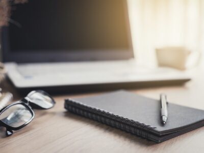 Notebook and laptop in home office with soft light
