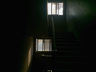 Light coming in from a window/ stairs. Stairway. Dark. Shadow. Light.