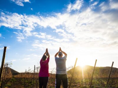 Yoga and meditation position with two aged senior man and woman together giving thanks to the sun