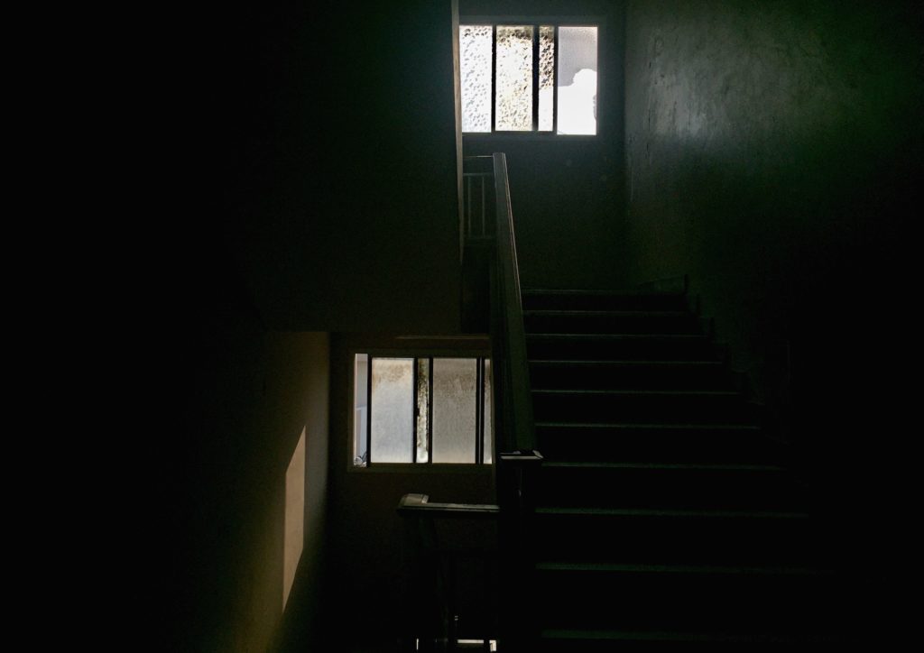 Light coming in from a window/ stairs. Stairway. Dark. Shadow. Light.